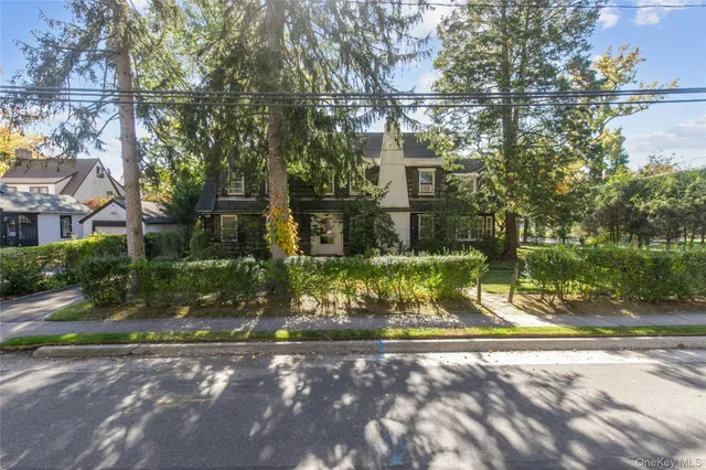 a view of a fountain with large trees