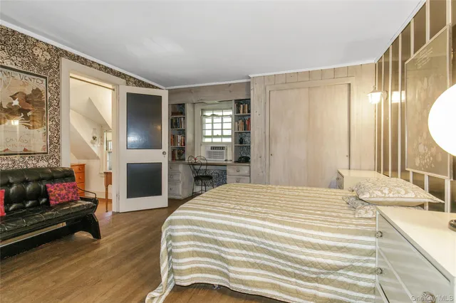 a bedroom with a bed and a television