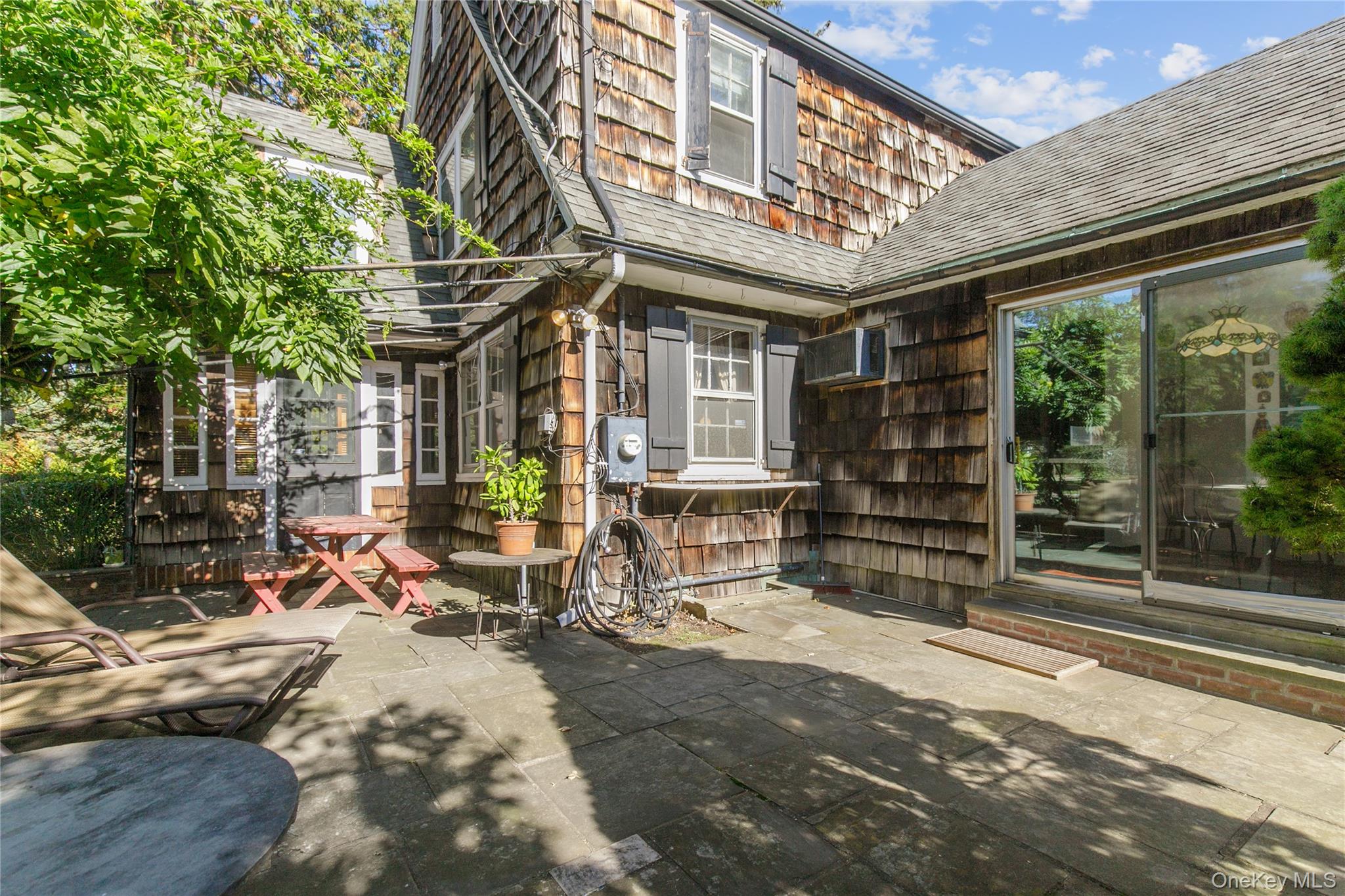 26 Vista Hill Road Great Neck, NY 11021 - Photo 27 of 35 a view of a chairs and table in the patio