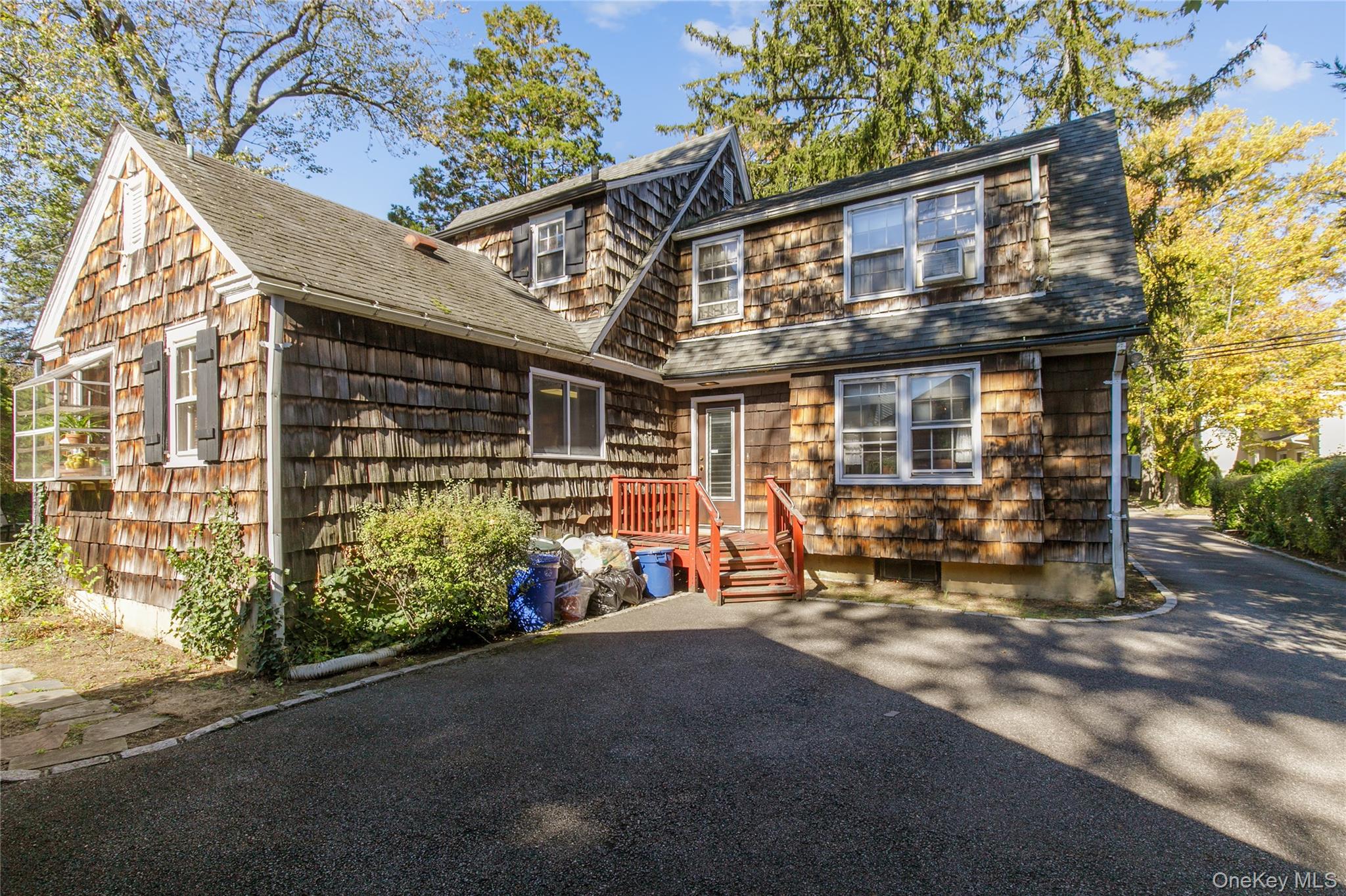 26 Vista Hill Road Great Neck, NY 11021 - Photo 3 of 35 a view of a house with a large windows and a small yard