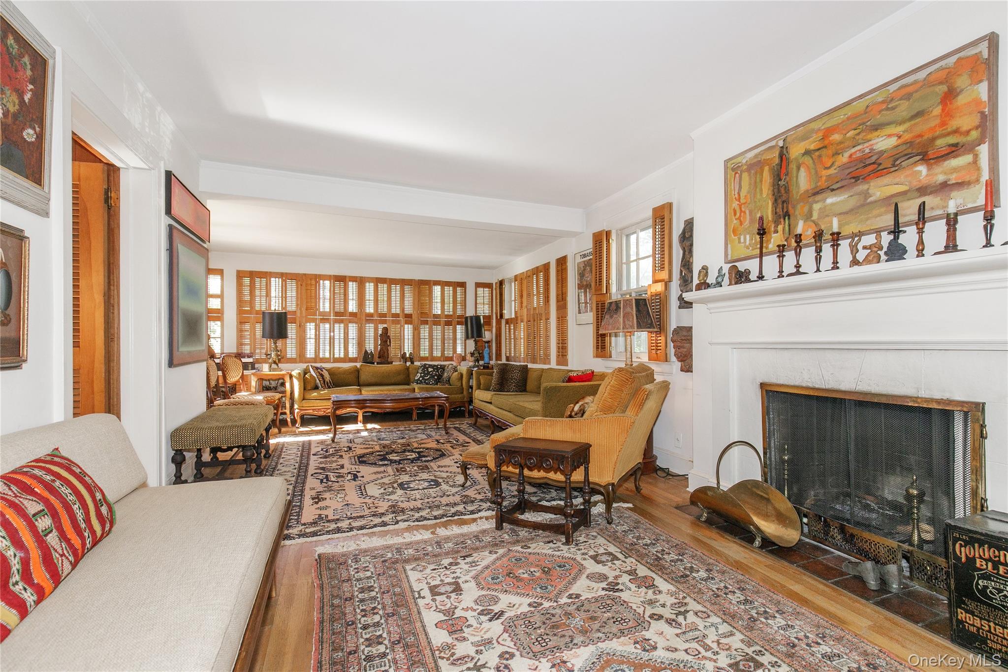 26 Vista Hill Road Great Neck, NY 11021 - Photo 9 of 35 a living room with furniture a fireplace and large windows