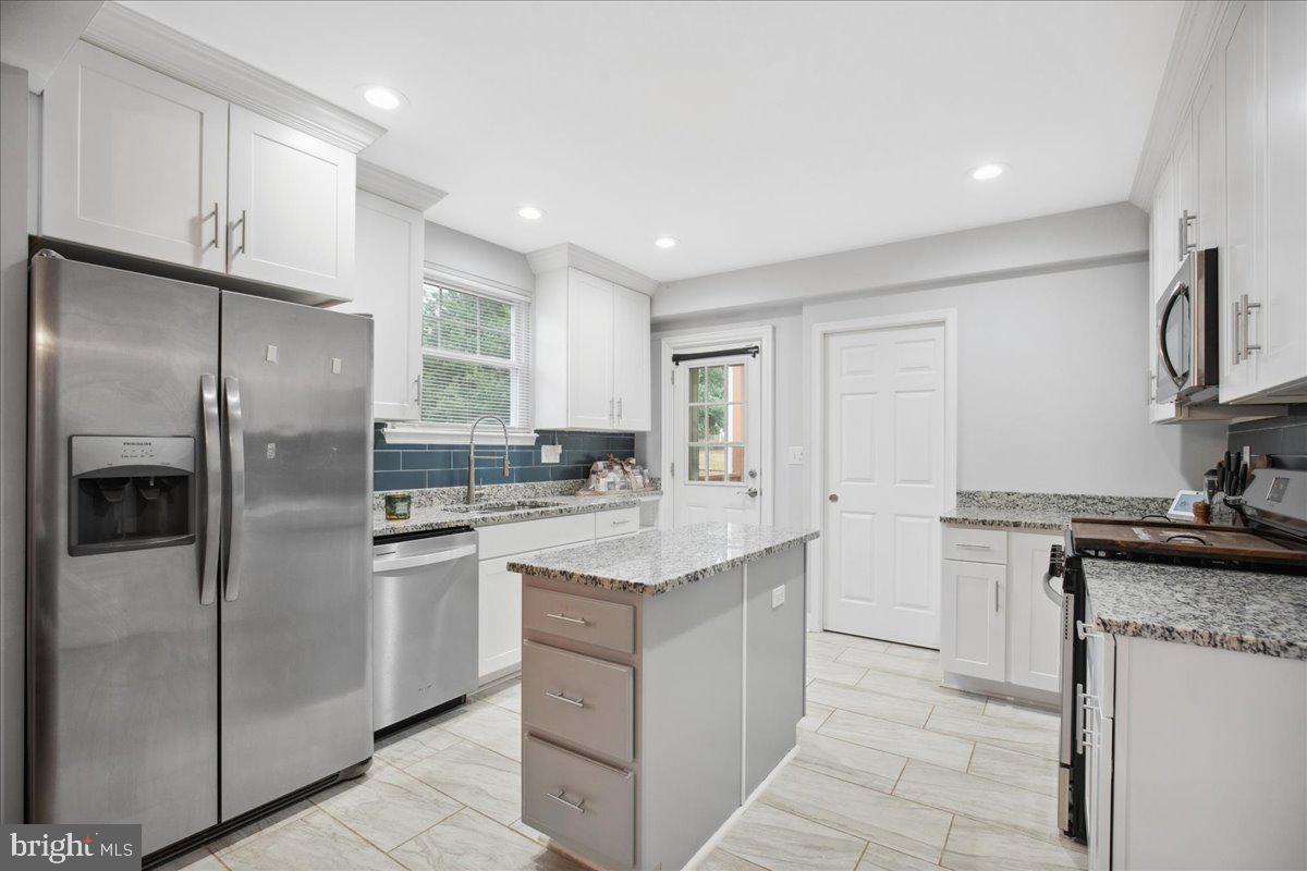 22 Cedarwood Road Catonsville, MD 21228 - Photo 13 of 44 a kitchen with stainless steel appliances granite countertop a refrigerator a sink and a stove