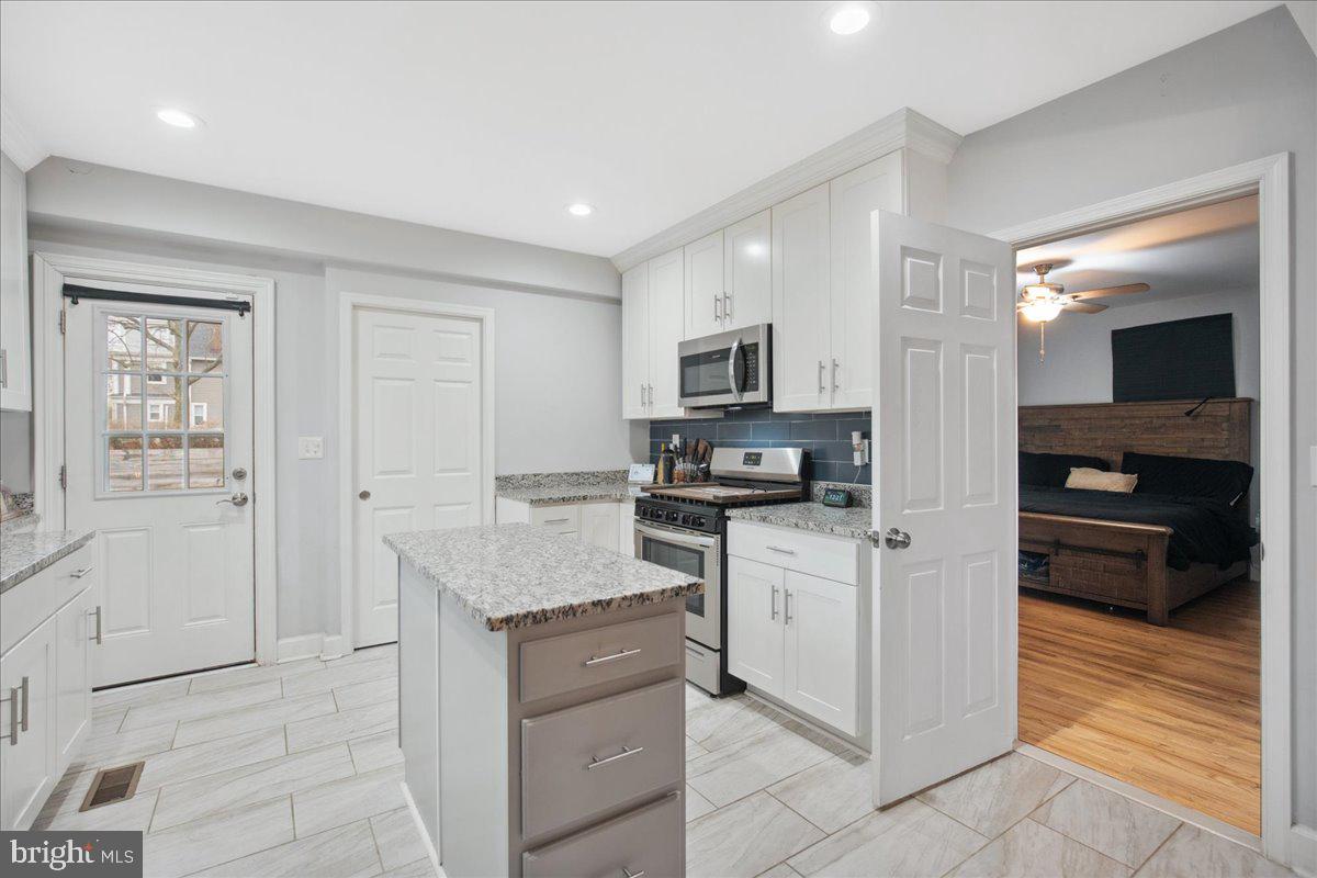 22 Cedarwood Road Catonsville, MD 21228 - Photo 14 of 44 a kitchen with white cabinets and appliances