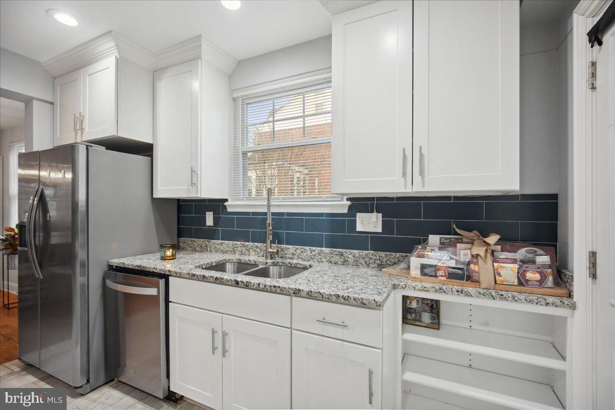 22 Cedarwood Road Catonsville, MD 21228 - Photo 15 of 44 a kitchen with stainless steel appliances granite countertop a refrigerator sink and cabinets