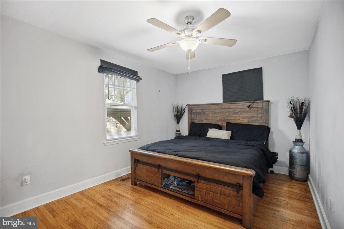 22 Cedarwood Road Catonsville, MD 21228 - Photo 18 of 44 a bedroom with a bed and a chandelier