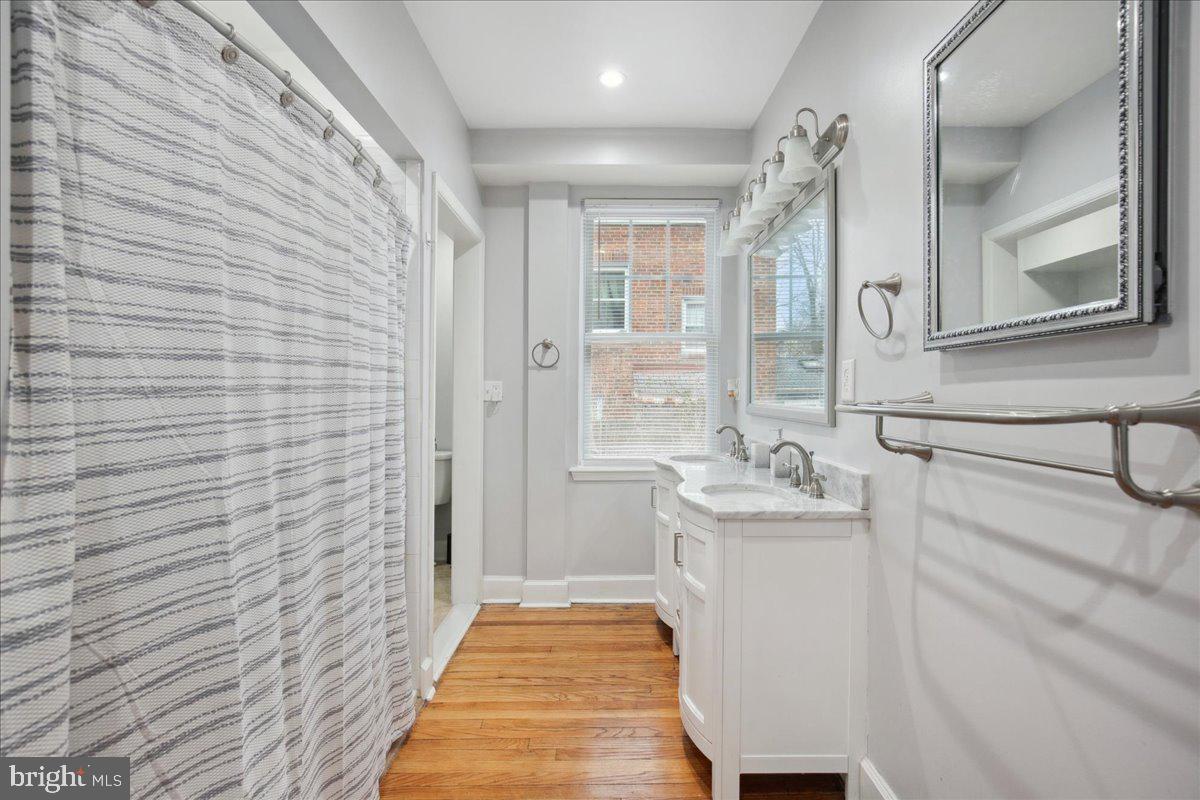 22 Cedarwood Road Catonsville, MD 21228 - Photo 19 of 44 a bathroom with a sink a toilet a mirror and shower