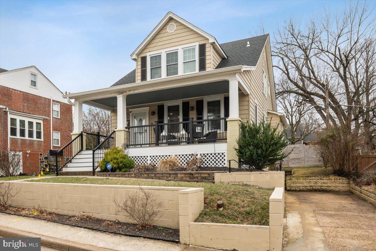 22 Cedarwood Road Catonsville, MD 21228 - Photo 2 of 44 a view of a white house with large windows and a table and chairs