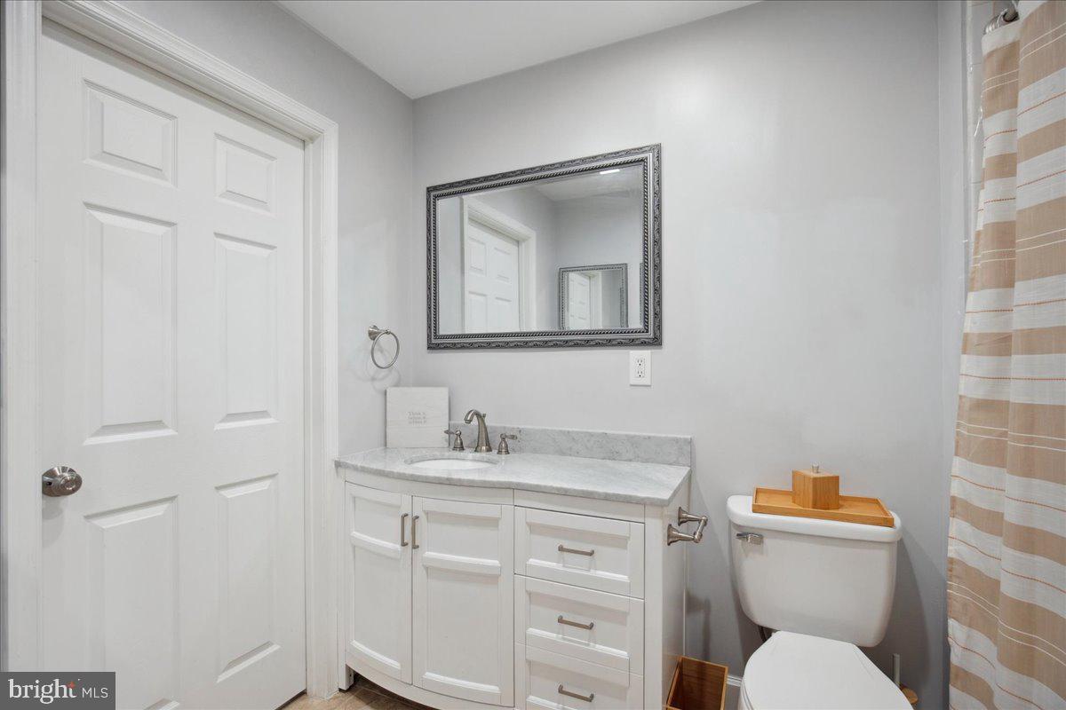 22 Cedarwood Road Catonsville, MD 21228 - Photo 26 of 44 a bathroom with a toilet sink vanity and mirror