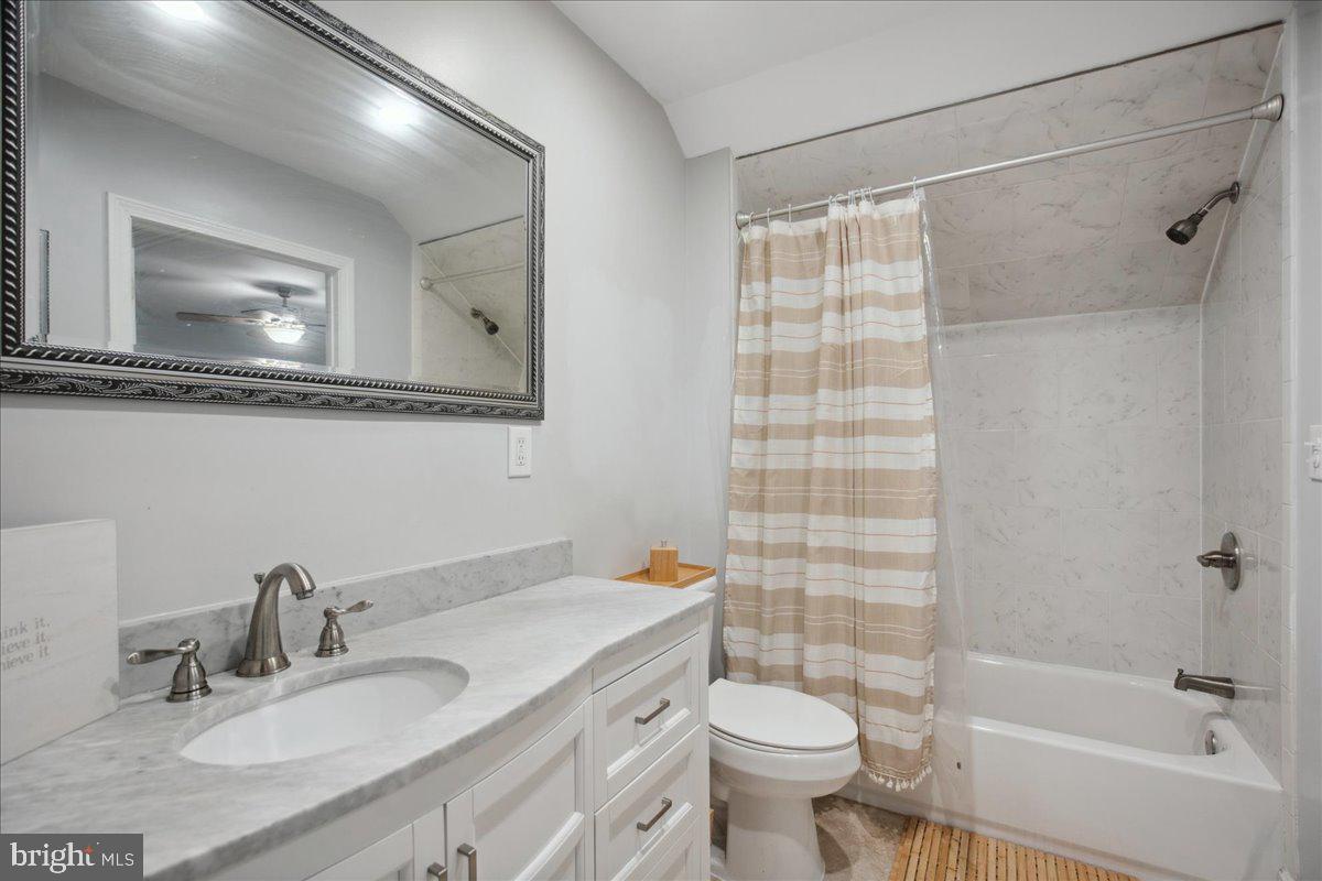 22 Cedarwood Road Catonsville, MD 21228 - Photo 27 of 44 a bathroom with a granite countertop sink mirror toilet and bathtub