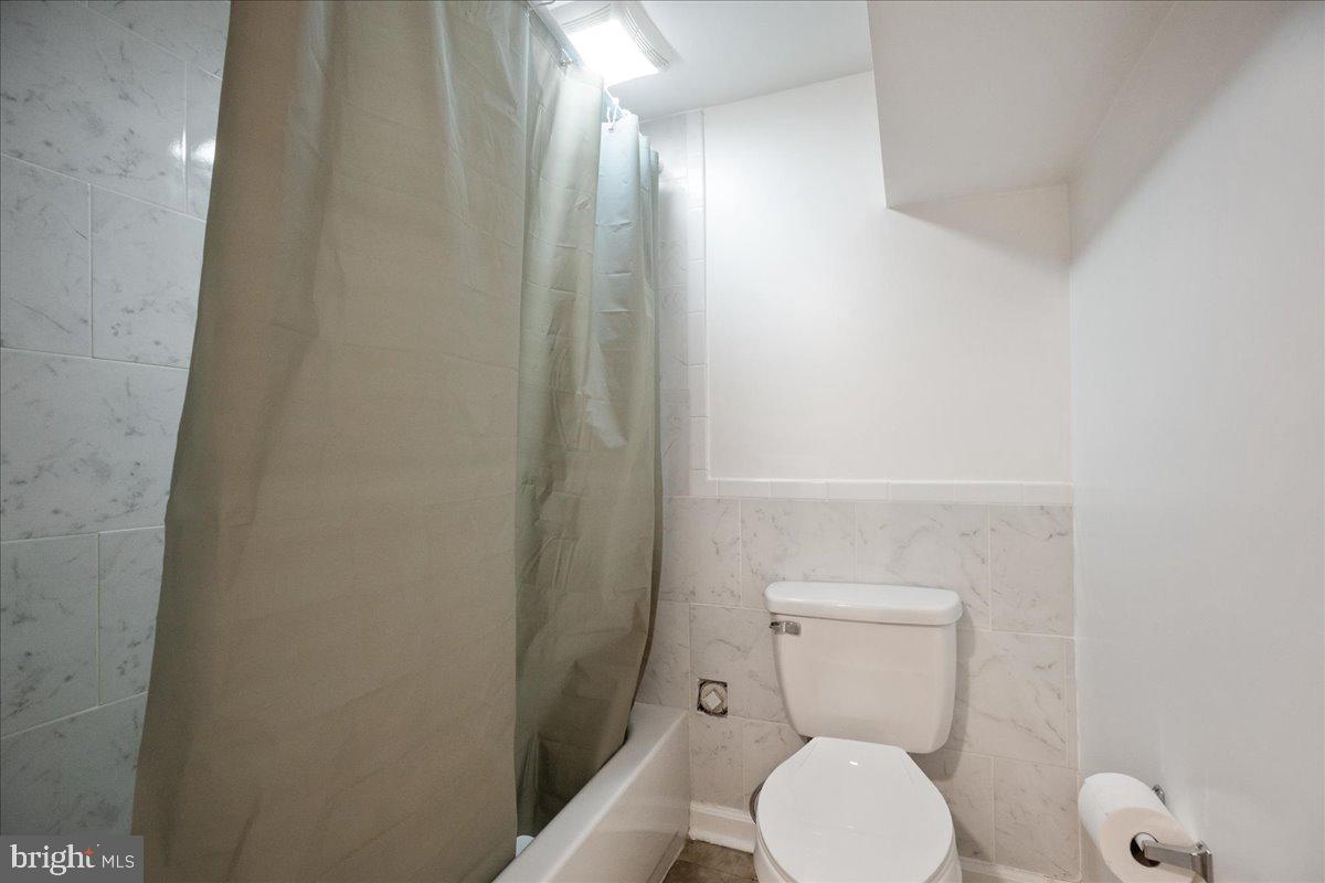 22 Cedarwood Road Catonsville, MD 21228 - Photo 34 of 44 a white toilet sitting next to a shower