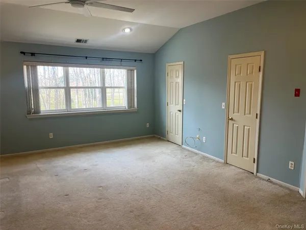 an empty room with a empty space and windows