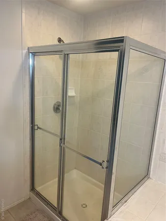 a bathroom with a glass shower door