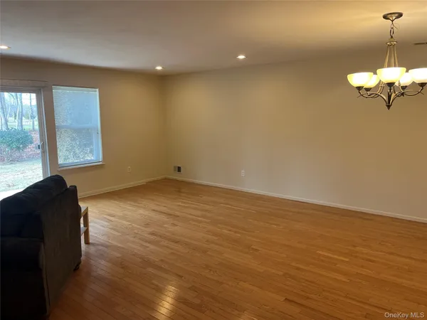 a view of a room with wooden floor and windows
