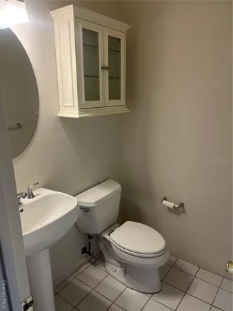 a white toilet sitting next to a bathroom sink