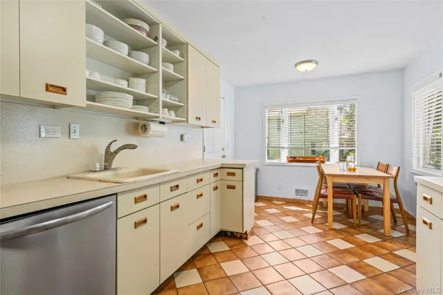 a kitchen with sink cabinets and window