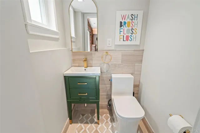 a bathroom with a toilet a sink and a mirror