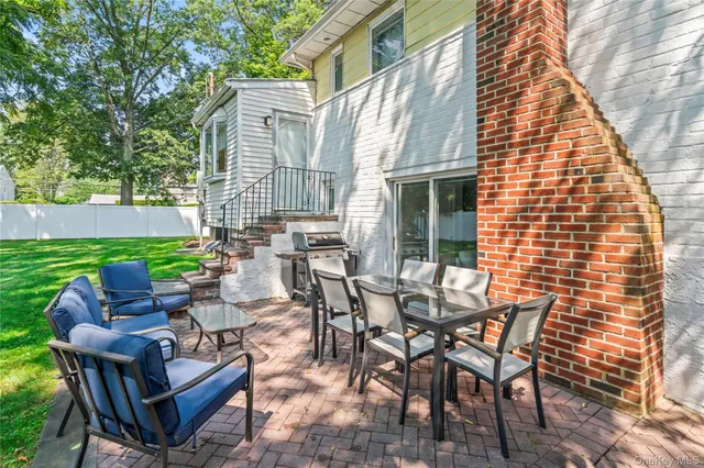 a view of a patio with table and chairs and potted plants