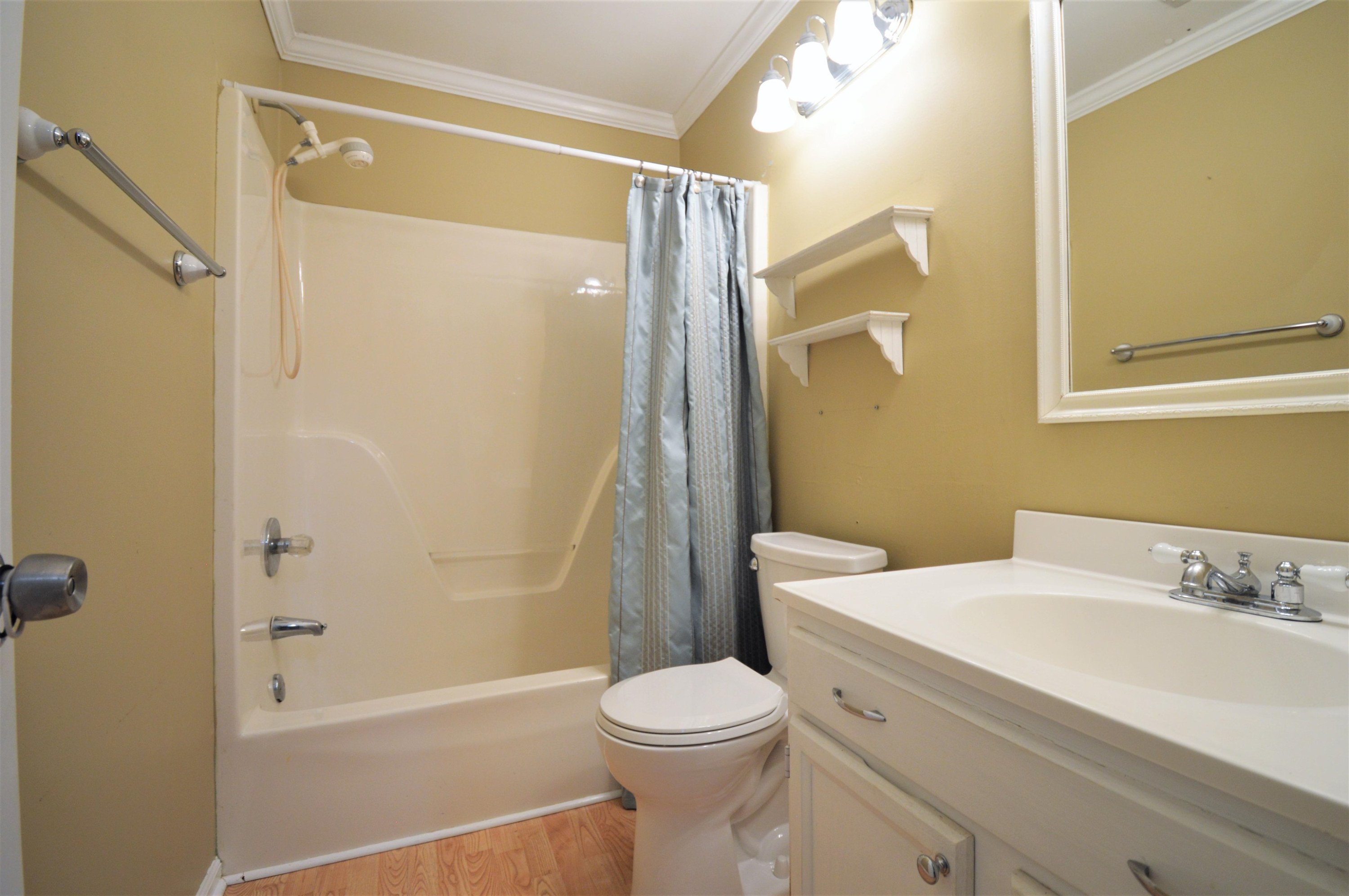 4965 Royal Adelaide Way Raleigh, NC 27604 - Photo 21 of 41 The hall bath has crown molding and laminate floor. The toilet was replaced in 2022. Hall Bath