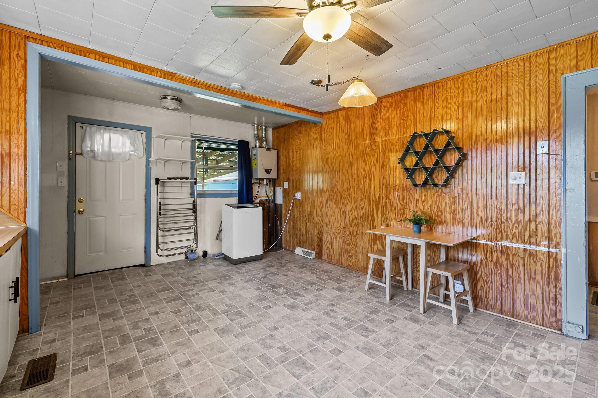 104 Pine Road Mount Holly, NC 28120 - Photo 13 of 46 a view of a workspace with furniture and a chandelier