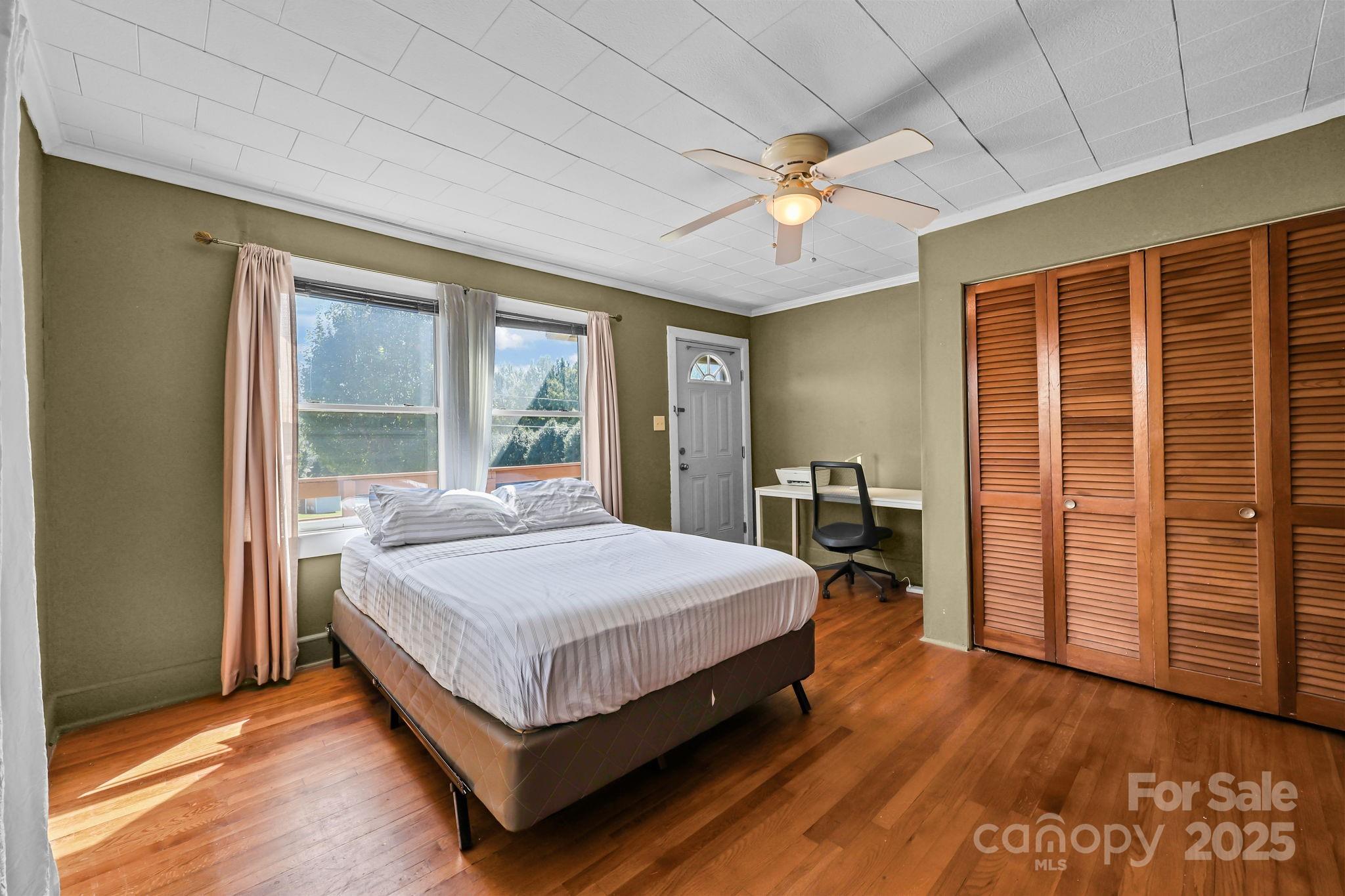 104 Pine Road Mount Holly, NC 28120 - Photo 15 of 46 a bedroom with a large bed and a large window