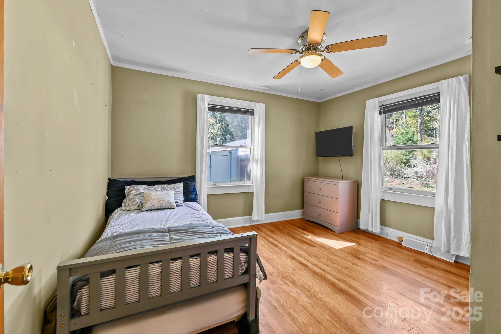 104 Pine Road Mount Holly, NC 28120 - Photo 18 of 46 a bedroom with a bed and a chandelier