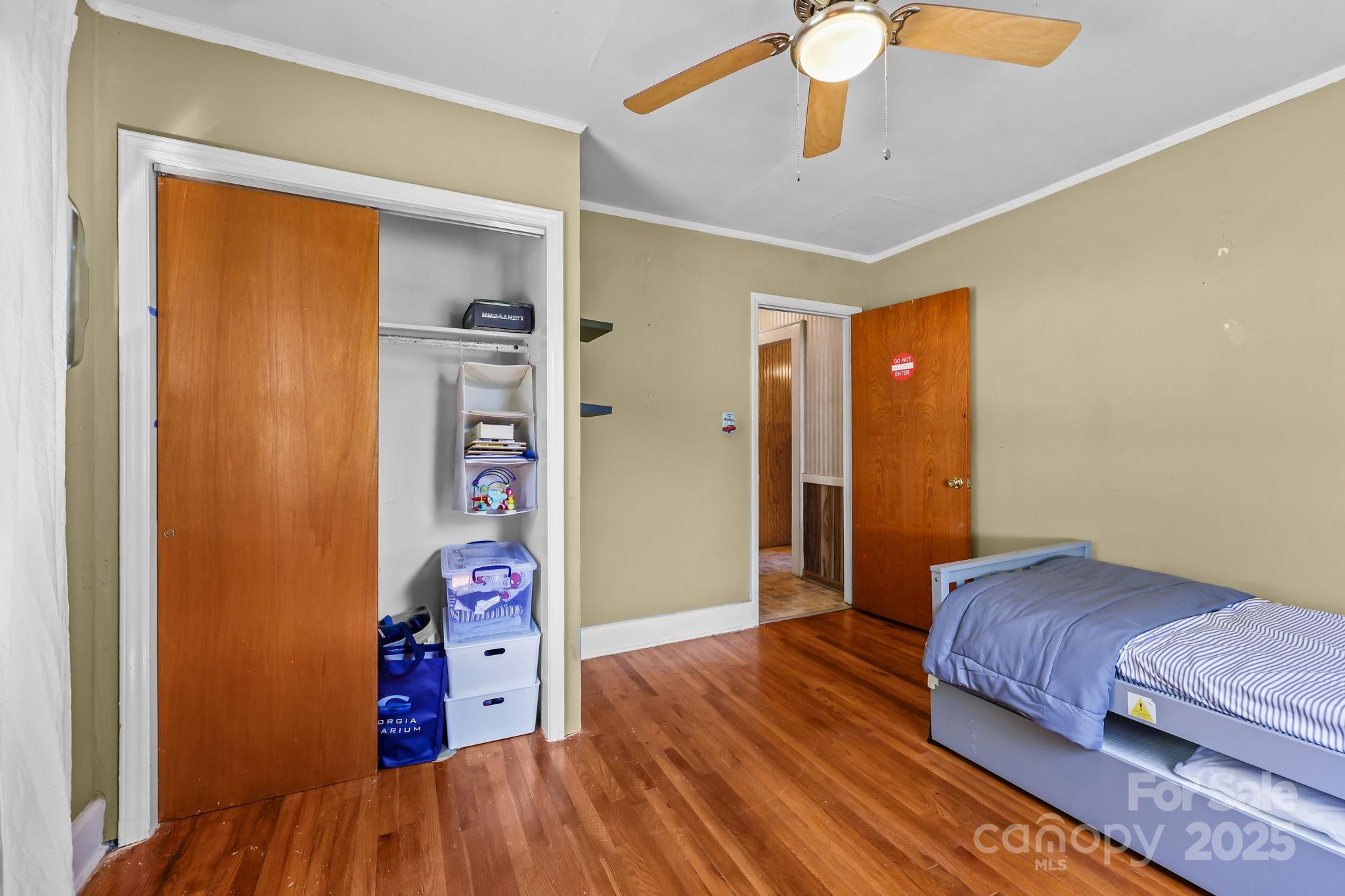 104 Pine Road Mount Holly, NC 28120 - Photo 19 of 46 a bedroom with bed and a chandelier