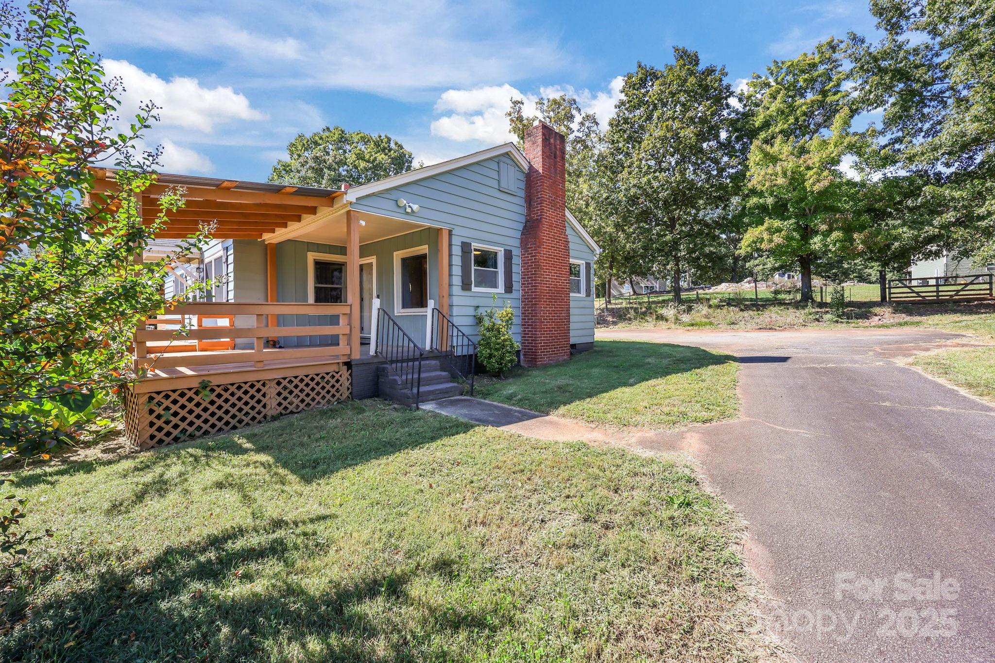 104 Pine Road Mount Holly, NC 28120 - Photo 28 of 46 a front view of a house with a yard and trees