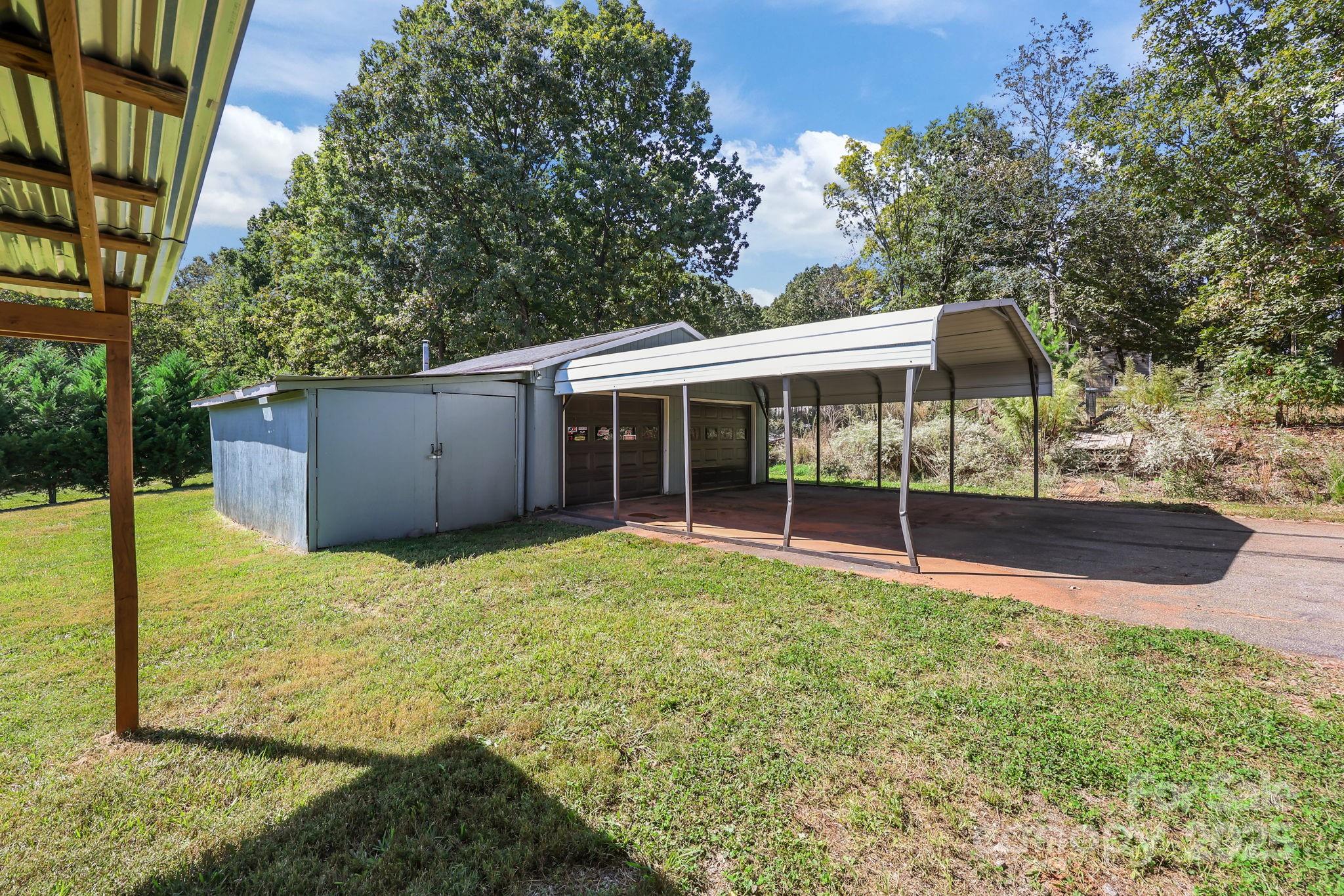 104 Pine Road Mount Holly, NC 28120 - Photo 30 of 46 a view of a house with backyard and sitting area