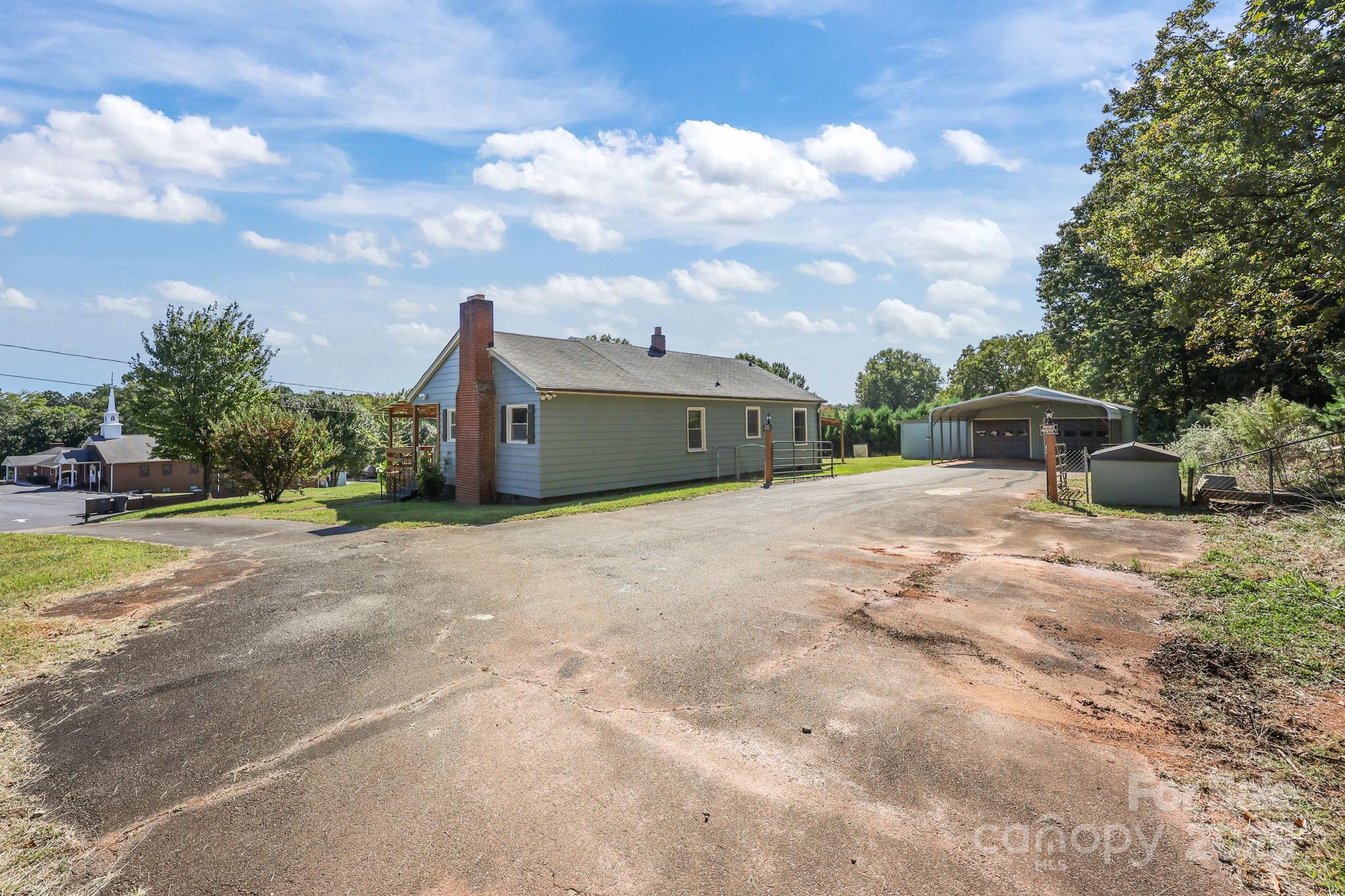 104 Pine Road Mount Holly, NC 28120 - Photo 35 of 46 a view of a house with backyard and garden