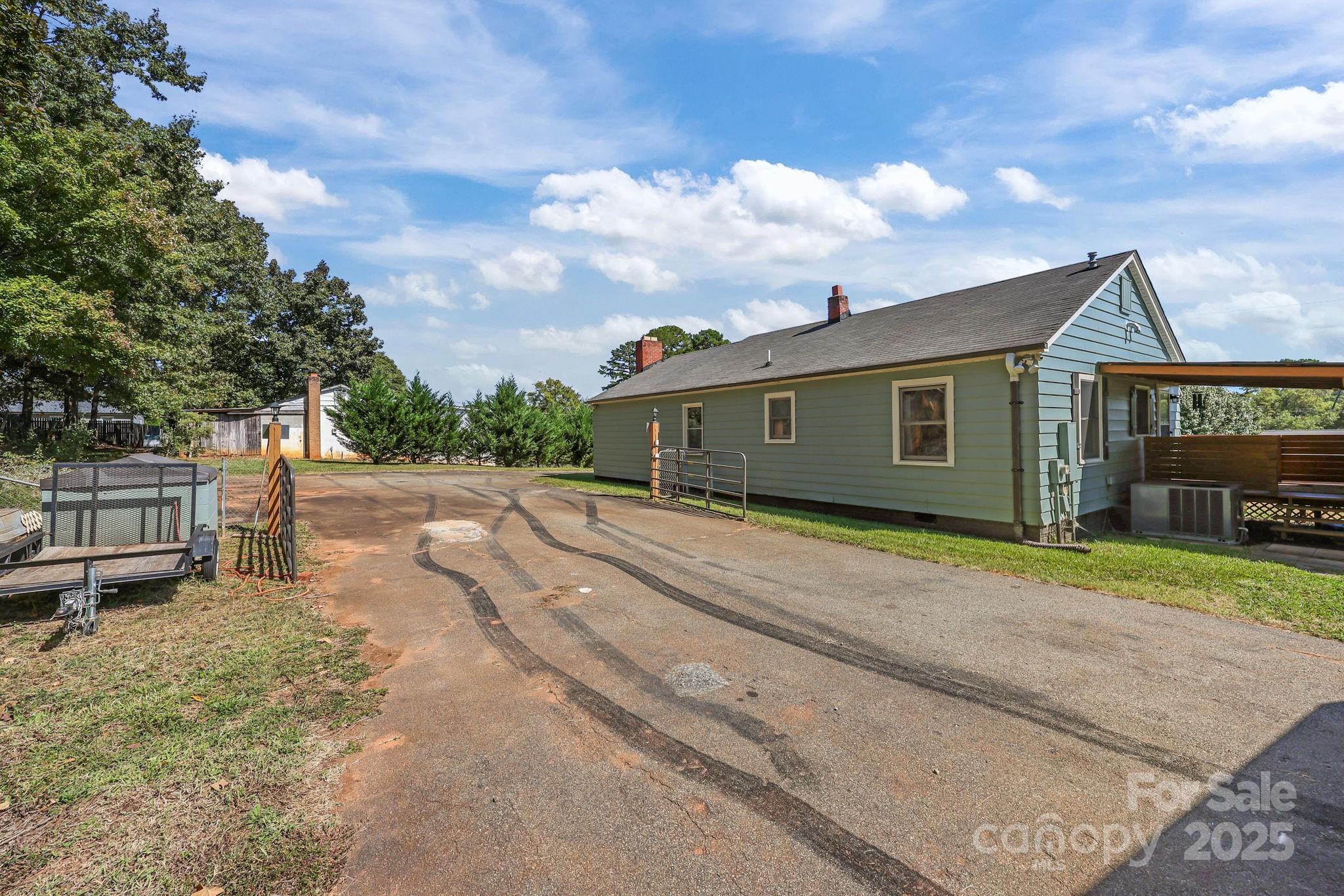104 Pine Road Mount Holly, NC 28120 - Photo 36 of 46 a front view of a house with a garden and yard