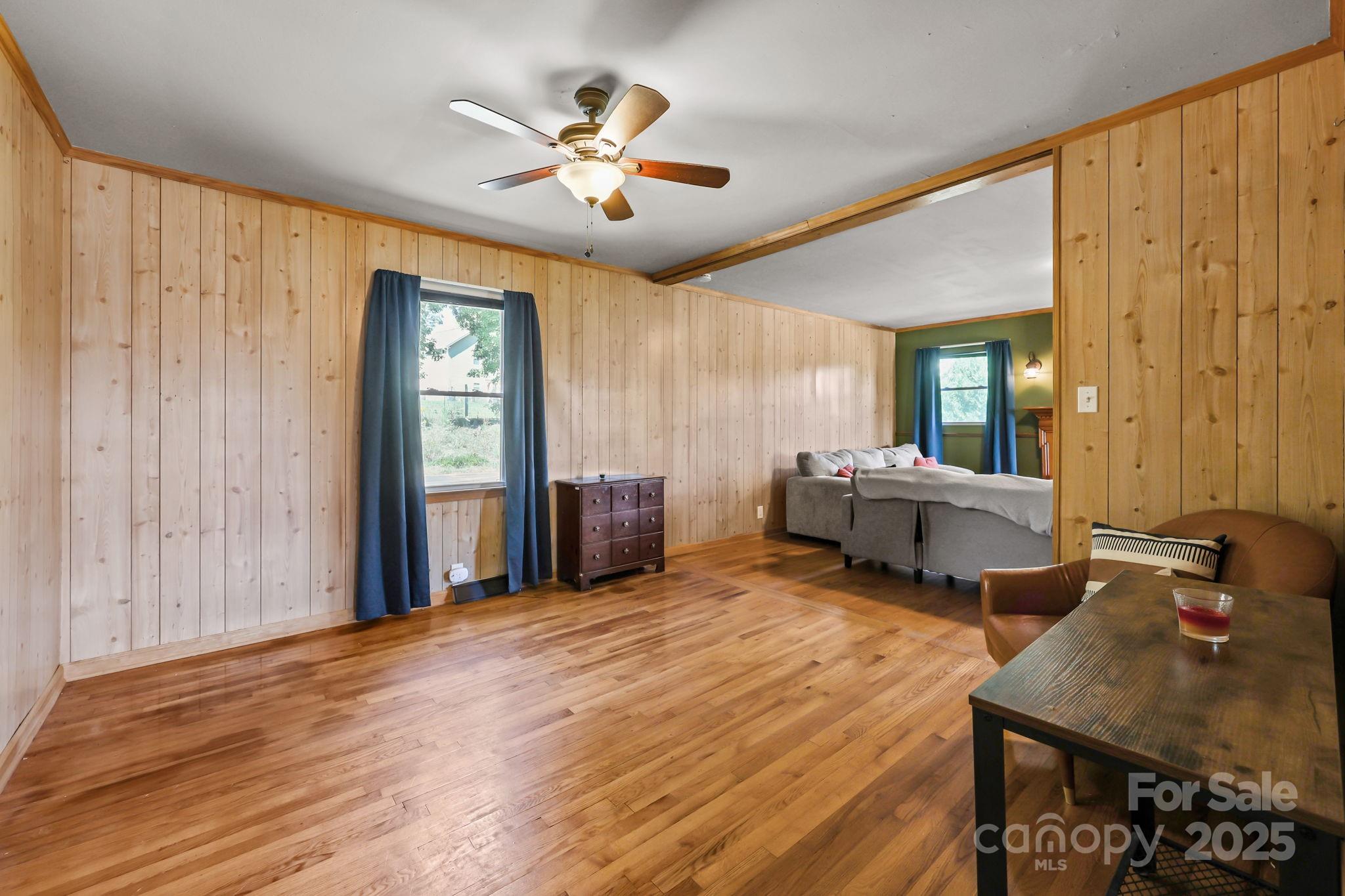 104 Pine Road Mount Holly, NC 28120 - Photo 6 of 46 a spacious bedroom with a bed and a chandelier