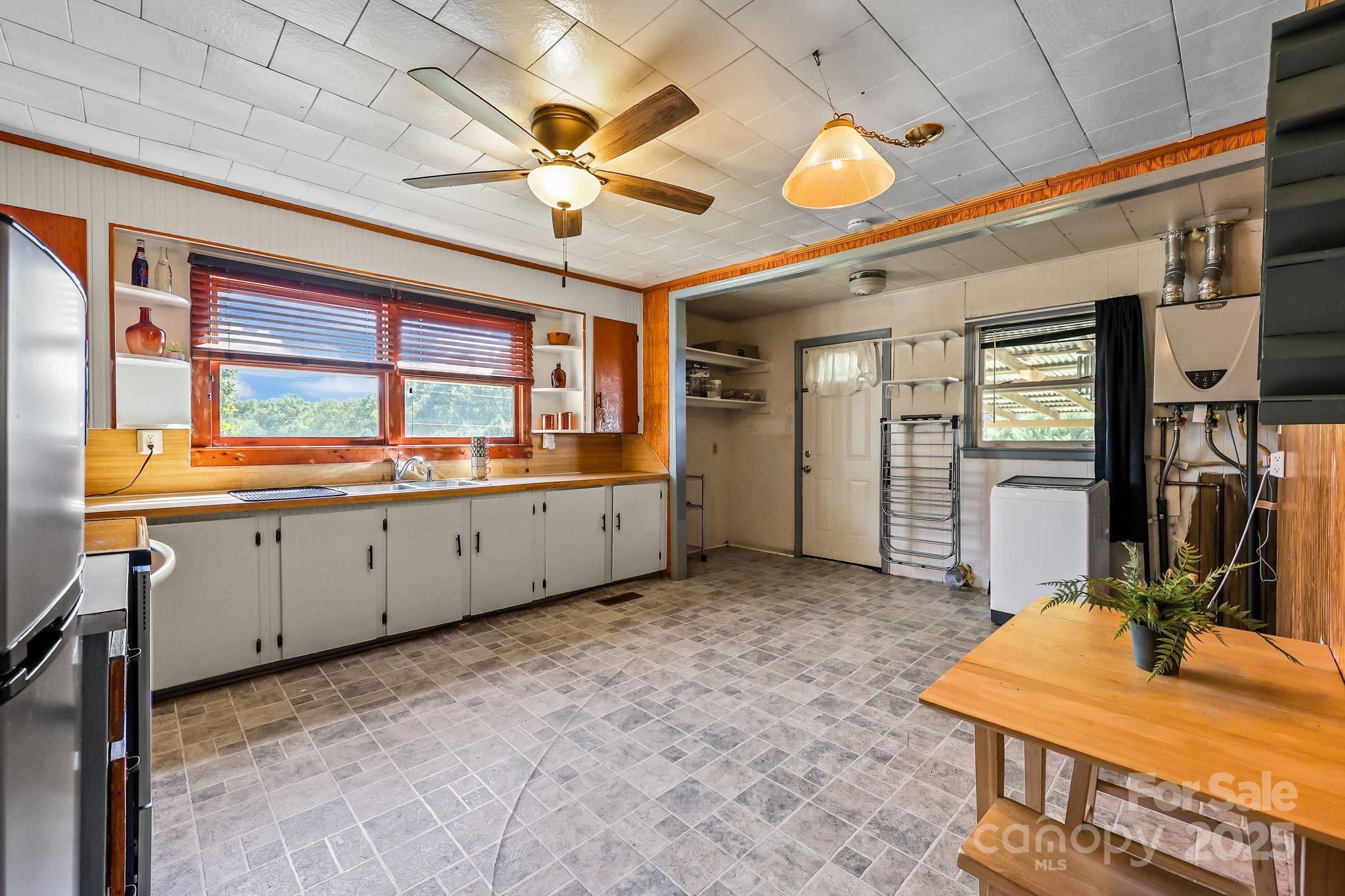104 Pine Road Mount Holly, NC 28120 - Photo 8 of 46 a view of a kitchen with a sink and cabinet with wooden floor
