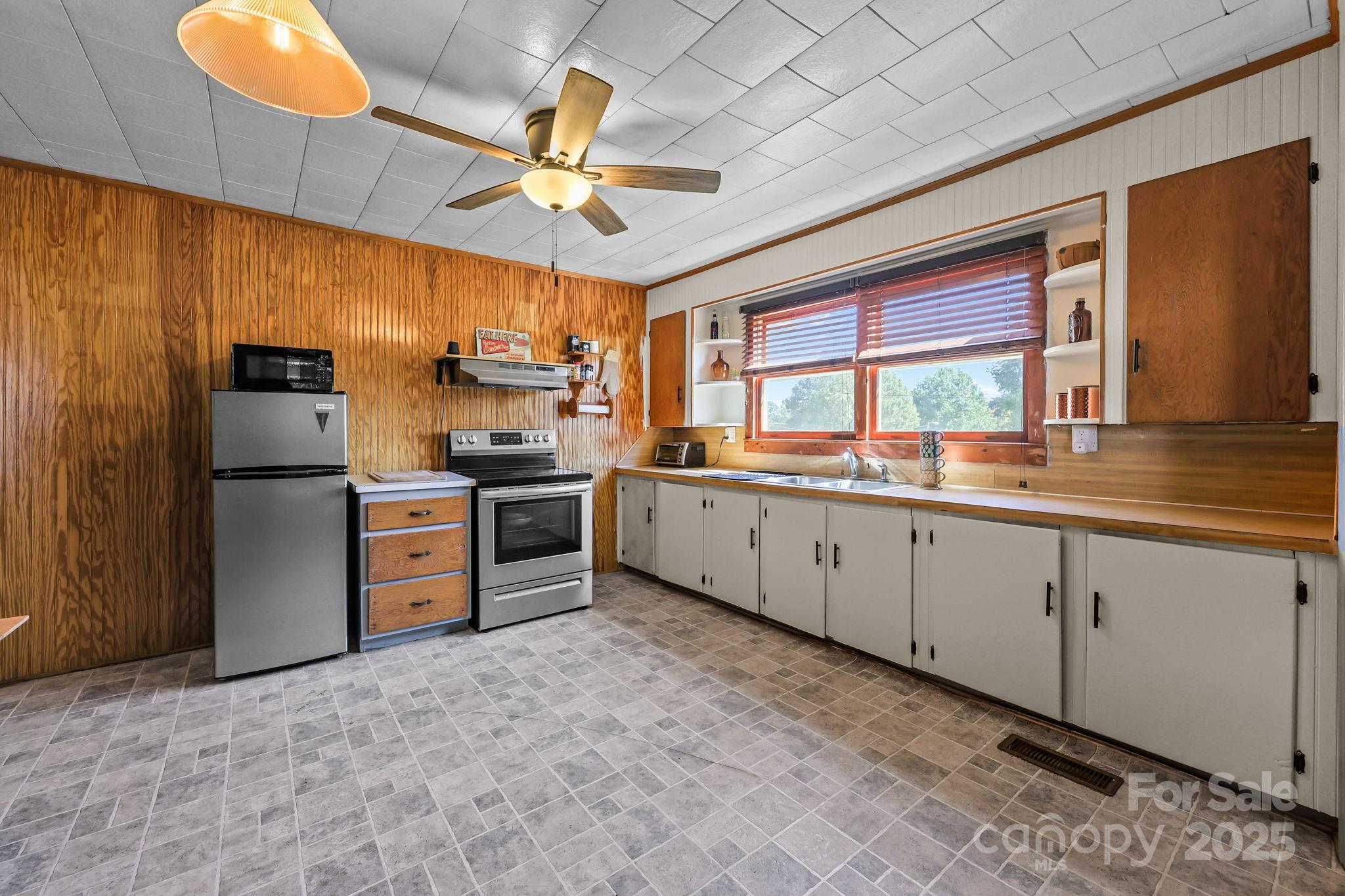 104 Pine Road Mount Holly, NC 28120 - Photo 9 of 46 a kitchen with a refrigerator sink and cabinets