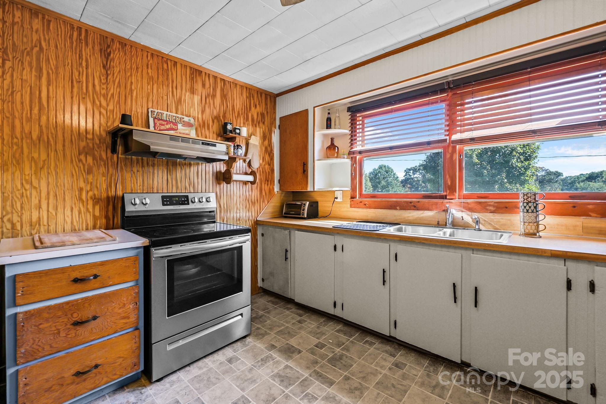 104 Pine Road Mount Holly, NC 28120 - Photo 10 of 46 a kitchen with stainless steel appliances granite countertop a stove and a sink