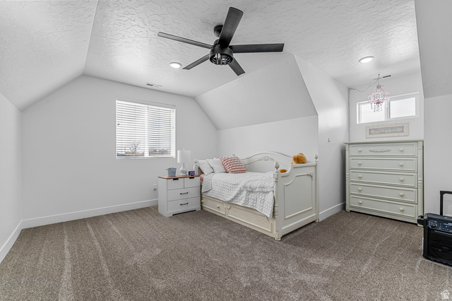 1426 South 1450th Street West Mapleton, UT 84664 - Photo 23 of 50 Attic space featuring sloped ceilings, textured white walls, and gray carpet flooring