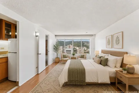 a bedroom with a bed and a large window