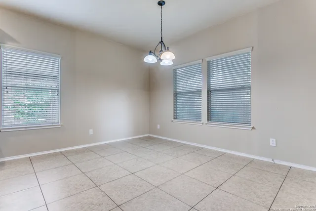 a view of an empty room with windows