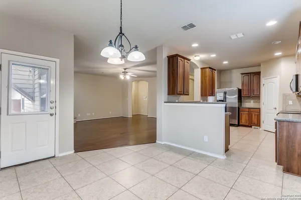 a view of a kitchen with a sink and refrigerator