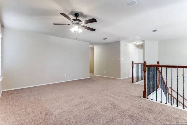a view of an empty room with a fan
