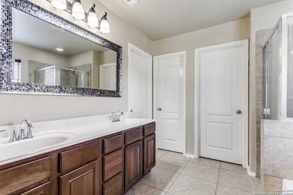 a bathroom with a double vanity sink and a mirror