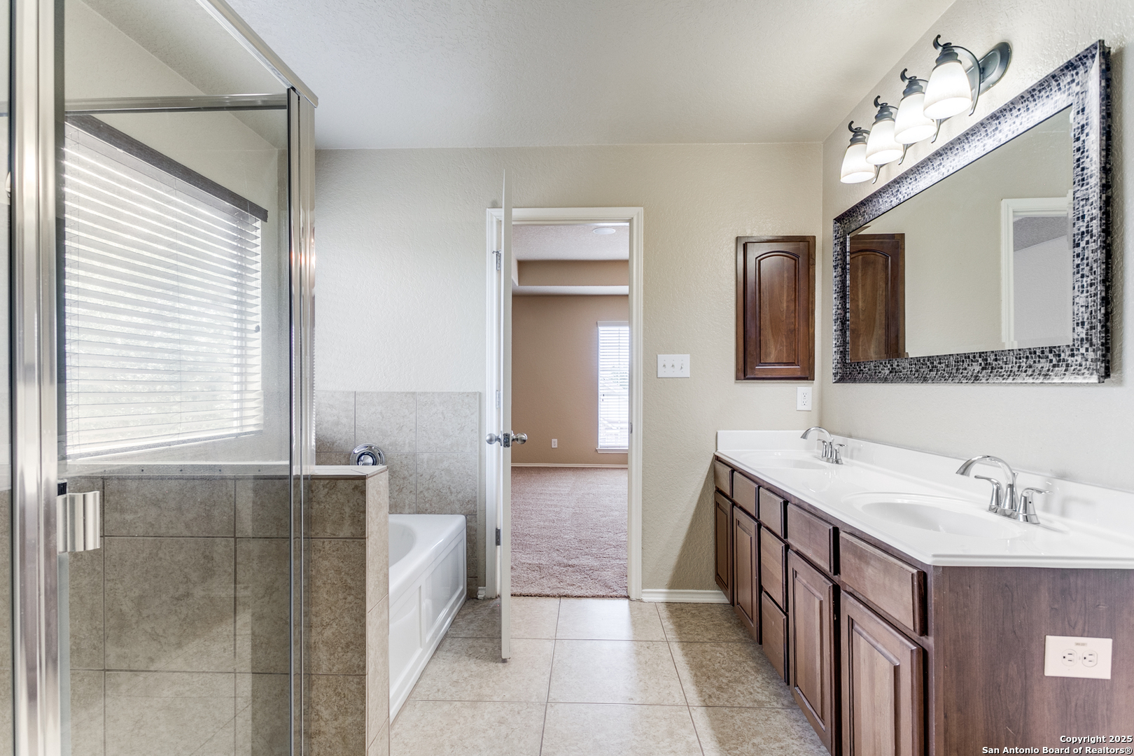3418 Alonzo Fields Converse, TX 78109 - Photo 29 of 36 a spacious bathroom with a double vanity sink a mirror and a bathtub