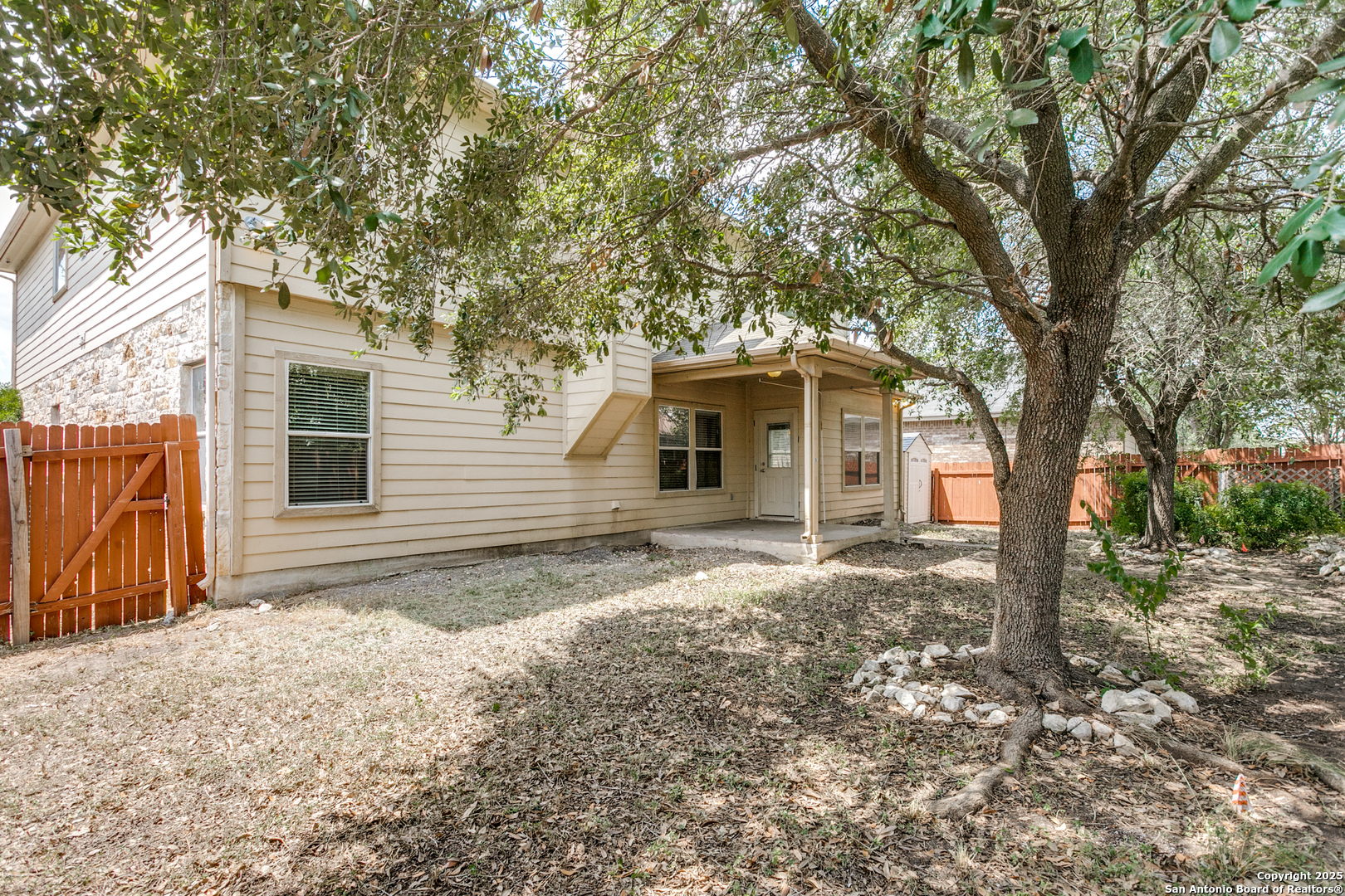 3418 Alonzo Fields Converse, TX 78109 - Photo 36 of 36 a backyard of a house with large trees and brick walls