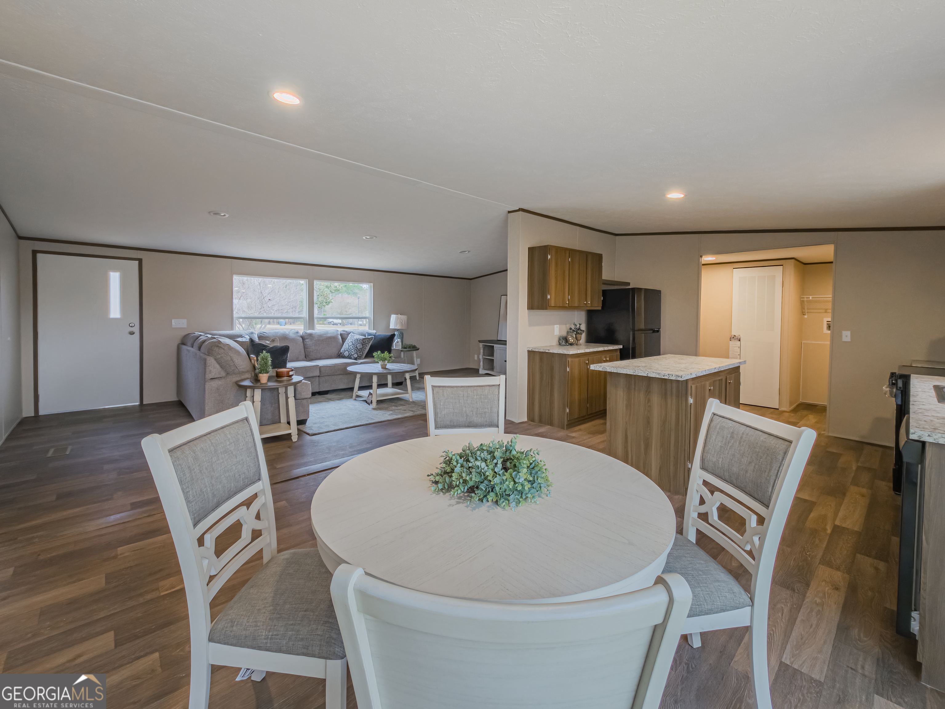 112 Courtney Circle Sumner, GA 31789 - Photo 12 of 32 a living room with furniture a dining table and kitchen view
