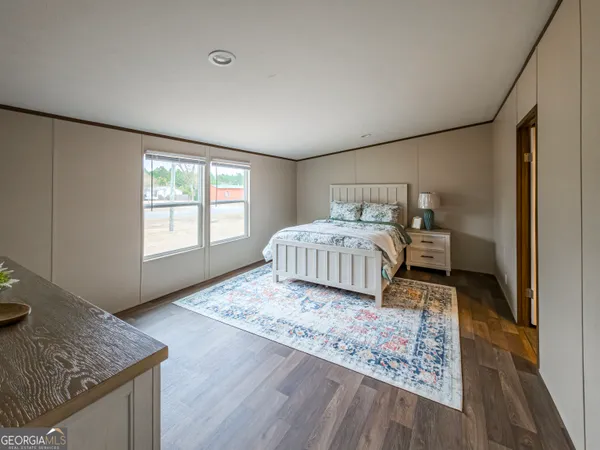 a living room with a bed and furniture