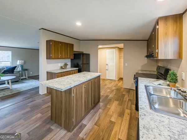 a kitchen with stainless steel appliances granite countertop a sink stove and cabinets