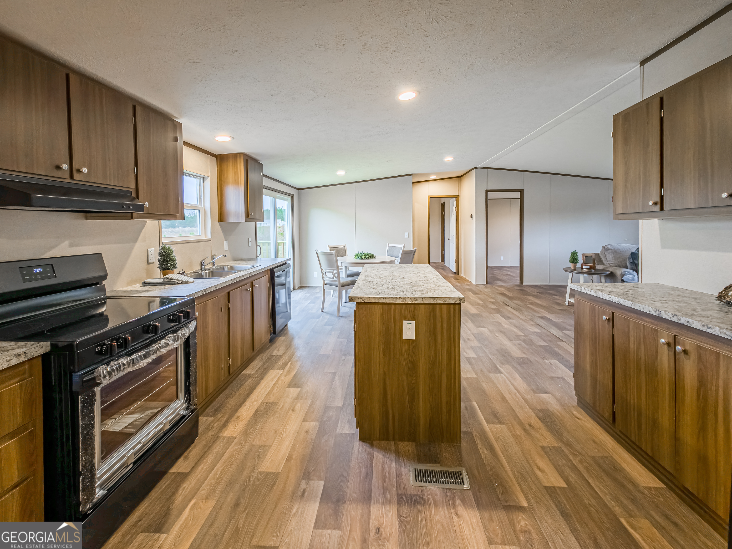 112 Courtney Circle Sumner, GA 31789 - Photo 10 of 32 a kitchen with stainless steel appliances granite countertop a stove a sink and a refrigerator