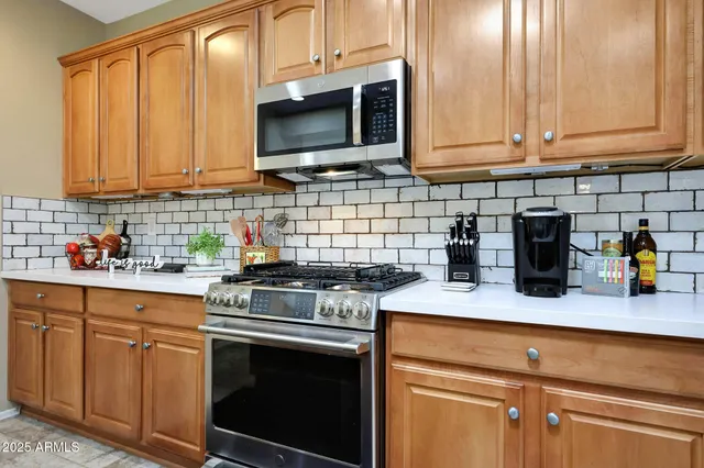 a kitchen with a sink stove and refrigerator