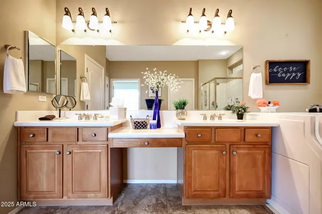 a bathroom with a double vanity sink mirror and shower