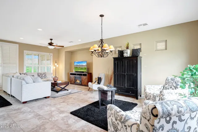 a living room with furniture chandelier and a table