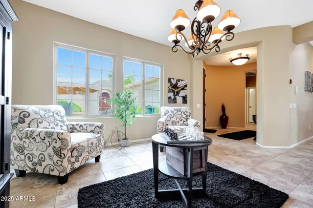 a living room with furniture and a chandelier
